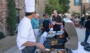 chef cooking food for residents at the grill outside