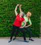 Mary with exercise coach doing stretches outside