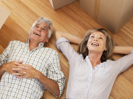 Senior man and woman lying on a hardwood floor