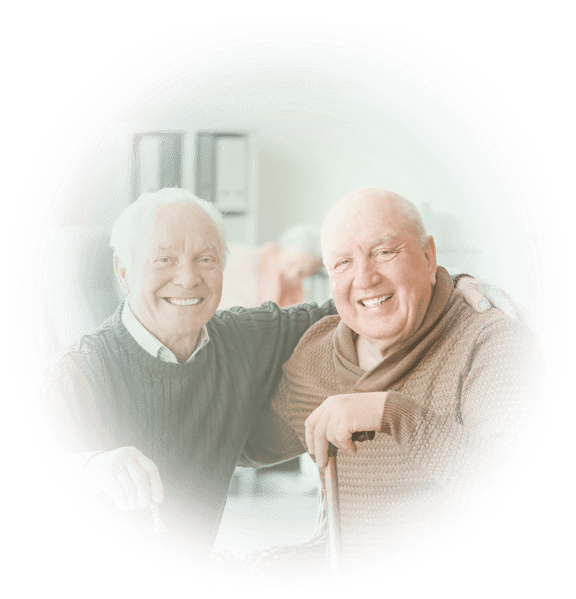 Two smiling senior men with their arms around each others' shoulders